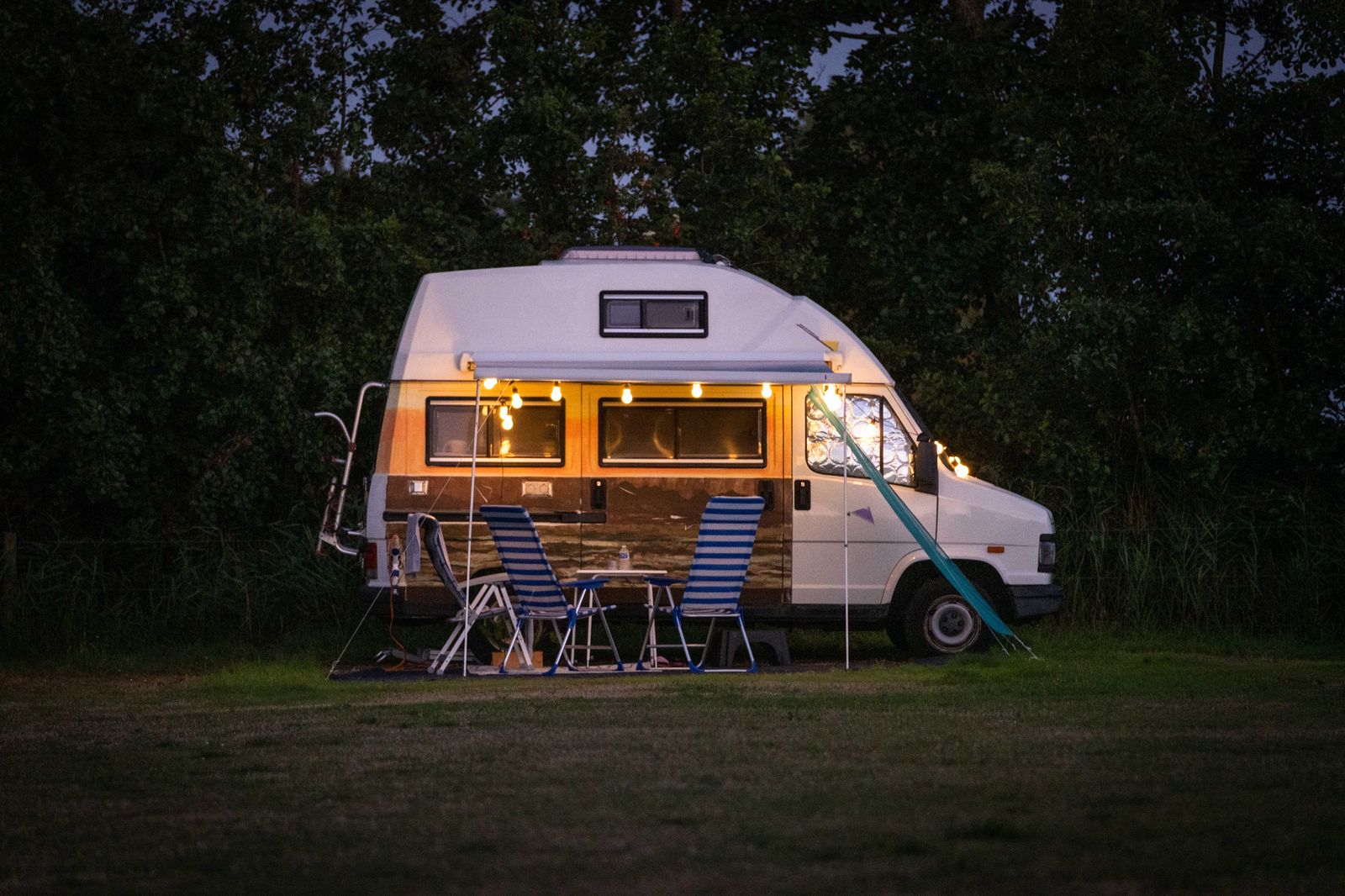 Kampeerbusje op een kampeerplaats in de avond op Camping Cupido
