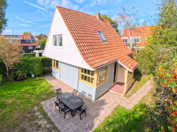 Vrijstaand huis met rood pannendak en terras met eettafel