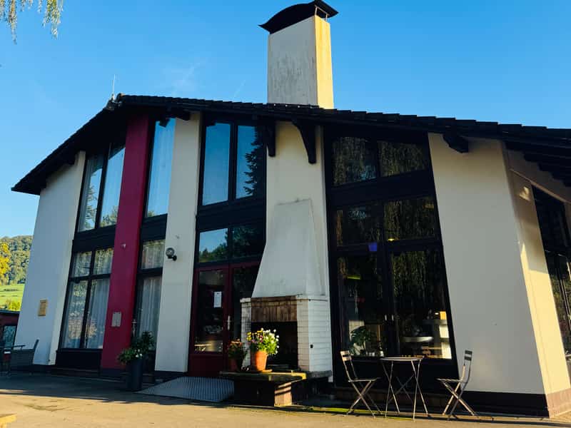 Huis met grote ramen onder een blauwe lucht